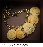 Handwork necklace, consisting of five peach-colored colors, made of cloth lies in a brown box. Стоковое фото, фотограф Олег Белов / Фотобанк Лори