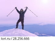 Mountaineer exults reaching the top of the mountain peak. Стоковое фото, фотограф Евгений Харитонов / Фотобанк Лори