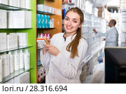 Smiling cheerful young female pharmacist posing. Стоковое фото, фотограф Яков Филимонов / Фотобанк Лори