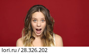 Female Face in Shock on red Close Up. Стоковое видео, видеограф Ekaterina Demidova / Фотобанк Лори