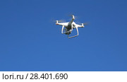 Летящий квадрокоптер DJI Phantom 4 на фоне голубого неба (2018 год). Редакционное видео, видеограф Виктор Карасев / Фотобанк Лори