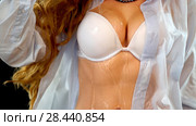 Sexual woman drinking water from bottle, pours on breasts. Стоковое фото, фотограф Gennadiy Poznyakov / Фотобанк Лори