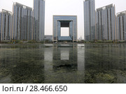 TIANJIN, CHINA - APRIL 8, 2017. A modern building along the Haihe River in Tianjin, China. Редакционное фото, фотограф Яна Королёва / Фотобанк Лори