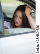 Young Woman Sending Messages in Car on Backseat. Стоковое фото, фотограф Kirill Kedrinskiy / Ingram Publishing / Фотобанк Лори