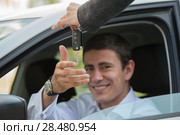 Car salesman handing over the keys for a new car to a young businessman. Стоковое фото, фотограф Kirill Kedrinskiy / Ingram Publishing / Фотобанк Лори