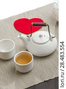 Valentine's day surprice for couple. Romantic tea set with red heart. Стоковое фото, фотограф Kirill Kedrinskiy / Ingram Publishing / Фотобанк Лори