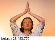 Yoga against the orange sky. Стоковое фото, фотограф Kirill Kedrinskiy / Ingram Publishing / Фотобанк Лори