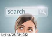 Technology, searching system and internet concept - woman looking at Search engine button overhead. Стоковое фото, фотограф Kirill Kedrinskiy / Ingram Publishing / Фотобанк Лори