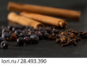 Cloves cinnamon juniper berries Gyn tonic spices on black background. Стоковое фото, агентство Ingram Publishing / Фотобанк Лори