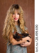 Children fashion farmer girl holding hen in retro vintage background. Стоковое фото, фотограф Tono Balaguer / Ingram Publishing / Фотобанк Лори