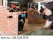 adult players are targeting in enemy behind barricades. Стоковое фото, фотограф Яков Филимонов / Фотобанк Лори