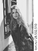 Pretty blond woman, model of fashion, in urban background. Beautiful girl wearing shirt and blue jeans. Black and white shoot. Стоковое фото, фотограф Javier Sánchez Mingorance / Ingram Publishing / Фотобанк Лори