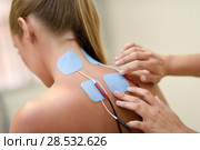 Electro stimulation in physical therapy to a young woman. Medical check at the shoulder in a physiotherapy center. Стоковое фото, фотограф Javier Sánchez Mingorance / Ingram Publishing / Фотобанк Лори