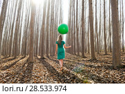Beautiful blonde girl, dressed in green, walking into the forest. Стоковое фото, фотограф Javier Sánchez Mingorance / Ingram Publishing / Фотобанк Лори