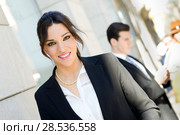 Portrait of an attractive businesswoman standing outside of company building. Couple working. Стоковое фото, фотограф Javier Sánchez Mingorance / Ingram Publishing / Фотобанк Лори