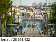 View of the city of Porto with the arch Dom Luis I bridge and  metro trams. At dawn. Редакционное фото, фотограф Сергей Цепек / Фотобанк Лори