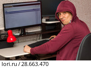 Интернет тролль у компьютера. Агрессивный молодой человек пишет вредные комментарии в сети. Стоковое фото, фотограф Лариса Капусткина / Фотобанк Лори