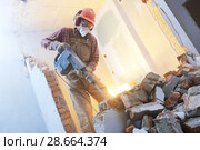 breaking interior wall. worker with demolition hammer. Стоковое фото, фотограф Дмитрий Калиновский / Фотобанк Лори