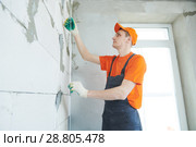 Plasterer installing screed on wall for plastering. Стоковое фото, фотограф Дмитрий Калиновский / Фотобанк Лори