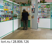 Gryazi, Russia - July 5. 2018. pensioner buys medicines in pharmacy in department of preferential provision. Редакционное фото, фотограф Володина Ольга / Фотобанк Лори