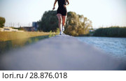 Young Woman In White Sneakers Running Near The River. Стоковое видео, видеограф Константин Шишкин / Фотобанк Лори