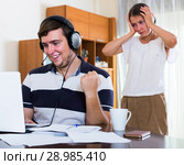 Angry spouse and person with internet addiction. Стоковое фото, фотограф Яков Филимонов / Фотобанк Лори