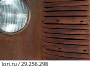 Fragment of the front of a rusted vintage car, part of the radiator and headlight. Стоковое фото, фотограф Евгений Харитонов / Фотобанк Лори