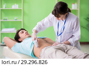 Young man visiting radiologyst for ultrasound procedure. Стоковое фото, фотограф Elnur / Фотобанк Лори