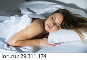 Young female in pygamas is sleeping on bed. Стоковое фото, фотограф Яков Филимонов / Фотобанк Лори