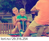 Company of kids are teetering on the swing. Стоковое фото, фотограф Яков Филимонов / Фотобанк Лори