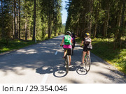 Active sporty women riding mountain bike on forest trail . Стоковое фото, фотограф Matej Kastelic / Фотобанк Лори