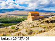 Beautuful View to Ancient Orthodox Church in mount in antique cave city Uplistsikhe. The Uplistsikhe 9th-10th century three-nave basilica and vale of Mtkvari river, Shida Kartli, Gori, Georgia. Стоковое фото, фотограф Алексей Ширманов / Фотобанк Лори