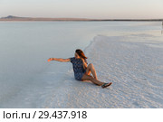 happy girl enjoying the sunset, touches water of a salt lake sitting on crystals. Стоковое фото, фотограф Ирина Мойсеева / Фотобанк Лори