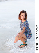 Pretty girl is squatting on the salt lake, expanse of Bascunchak salt lake. Стоковое фото, фотограф Ирина Мойсеева / Фотобанк Лори