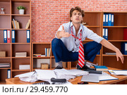 Unhappy businessman sitting in the office. Стоковое фото, фотограф Elnur / Фотобанк Лори