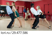 Adult pairs dancing tango movements in modern dance studio. Стоковое фото, фотограф Яков Филимонов / Фотобанк Лори