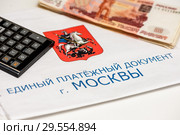 Единый платежный документ г. Москвы за коммунальные услуги, российские деньги и карманный калькулятор. Стоковое фото, фотограф Игорь Низов / Фотобанк Лори