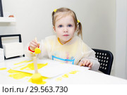 Cute lovely little girl painting with foam brush at home. Стоковое фото, фотограф ivolodina / Фотобанк Лори