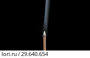 Incense stick with smoke on black background. Стоковое видео, видеограф Dzmitry Astapkovich / Фотобанк Лори