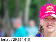 Russia, Samara, June 2018: beautiful football cheerleader smiling at the World Cup. Редакционное фото, фотограф Акиньшин Владимир / Фотобанк Лори