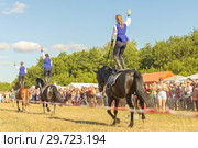 Russia, Samara, July, 2018: Cossack girls ride horses and perform tricks. Редакционное фото, фотограф Акиньшин Владимир / Фотобанк Лори