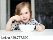 Lovely girl eating soup. Стоковое фото, фотограф ivolodina / Фотобанк Лори