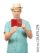 The man looks in the opened international passport. A look in a fullface. Стоковое фото, фотограф Владимир Арсентьев / Фотобанк Лори