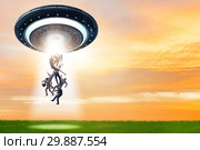 Flying saucer abducting young businessman. Стоковое фото, фотограф Elnur / Фотобанк Лори