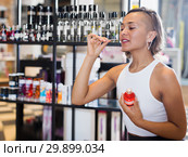 Adult woman buyer choosing bottle of pheromones. Стоковое фото, фотограф Яков Филимонов / Фотобанк Лори