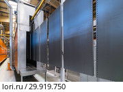 Powder coating line. Metal panels are suspended on an overhead conveyor line. Стоковое фото, фотограф Андрей Радченко / Фотобанк Лори
