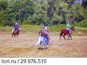 Russia, Samara, August 2018: Participants in the equestrian program "Competitions of the medieval riders." Military-historical festival "Warfare". Редакционное фото, фотограф Акиньшин Владимир / Фотобанк Лори