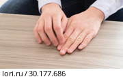 The hands of teenager who pulls the fingernails. Стоковое видео, видеограф Володина Ольга / Фотобанк Лори