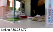 Female hand with money in cash department window. Стоковое видео, видеограф Ekaterina Demidova / Фотобанк Лори