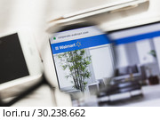 New York, USA - 6 March 2019: Walmart, Retail official website homepage under magnifying glass. Concept Walmart, Retail logo visible on smartphone, tablet screen. Редакционное фото, фотограф Сергей Тимофеев / Фотобанк Лори